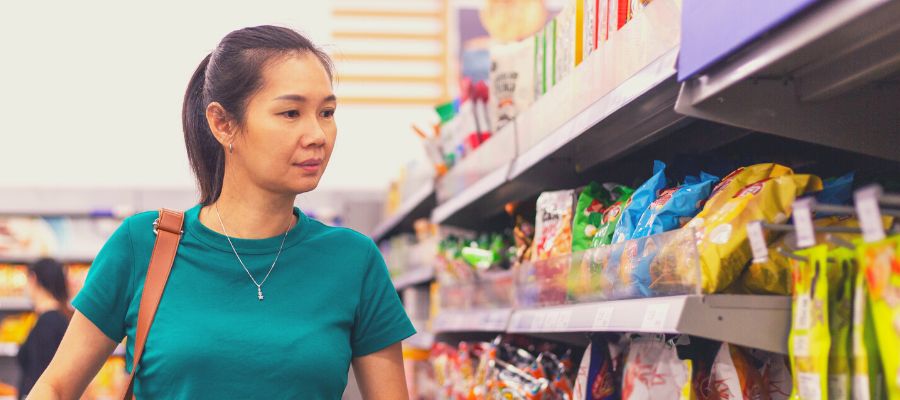 Woman in snack aisle at store