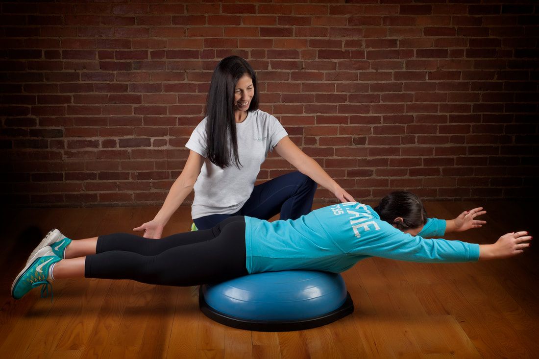 Woman Exercising with Trainer